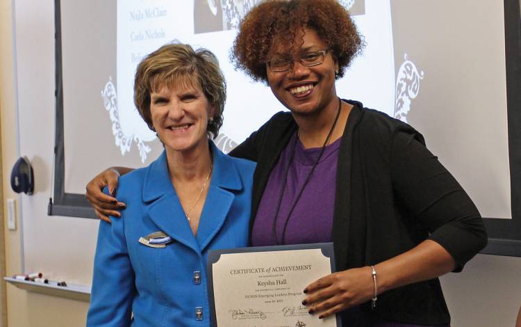 Marion Broome, left, dean of the Duke University School of Nursing, congratulates one of the first graduates of the school’s Emerging Leaders Program, Keysha Hall, right.