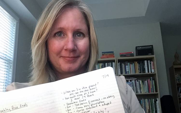 Jennifer Ahern-Dodson writes down what she accomplishes in a pomodoro in a small notebook at her home office. Photo courtesy of Jennifer Ahern-Dodson.