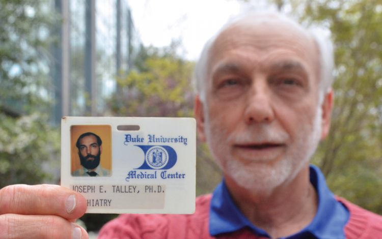 Dr. Joe Talley holds his original Duke identification card. Photo by Stephen Schramm.
