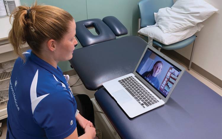 Duke Sports Medicine Clinic’s Kristina Wulff speaks with patient Caroline Garrett during a virtual visit. Photo courtesy of Kristina Wulff. Duke Sports Medicine Clinic’s Kristina Wulff speaks with patient Caroline Garrett during a virtual visit. Photo courtesy of Kristina Wulff.