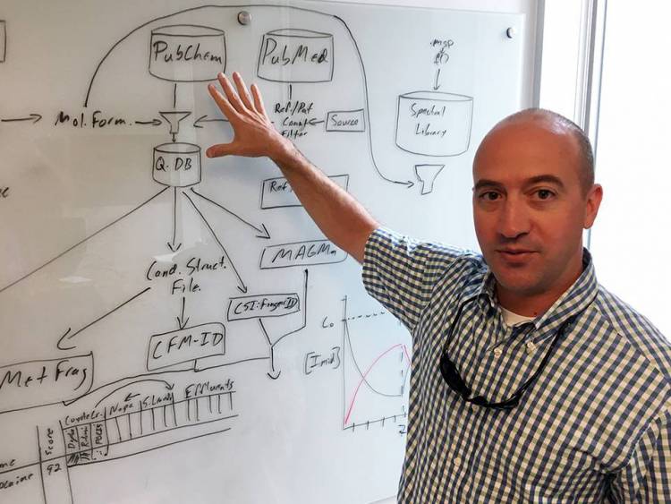 Lee Ferguson shows a schematic of the data processing system for a new state-funded water-testing system in his Gross Hall office