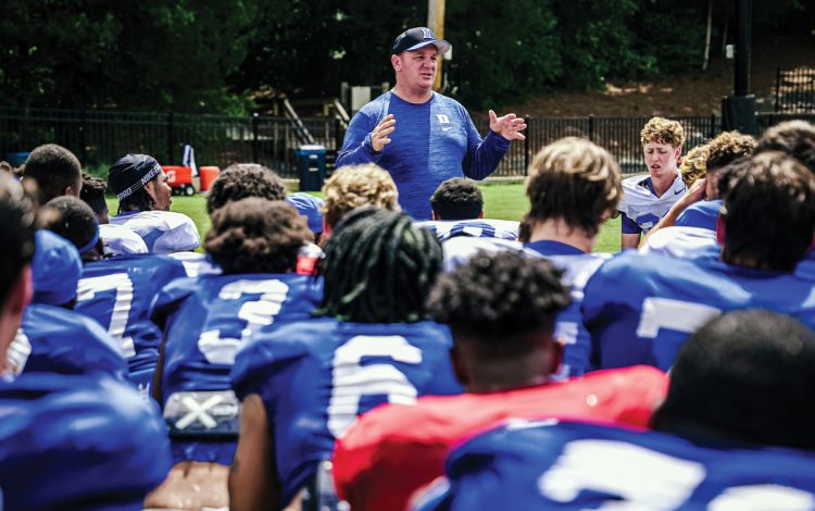 Duke football coach Mike Elko speaks with his 110 players after practice. This summer, his team has been focused on embracing the grind. Photo courtesy of Duke Athletics.