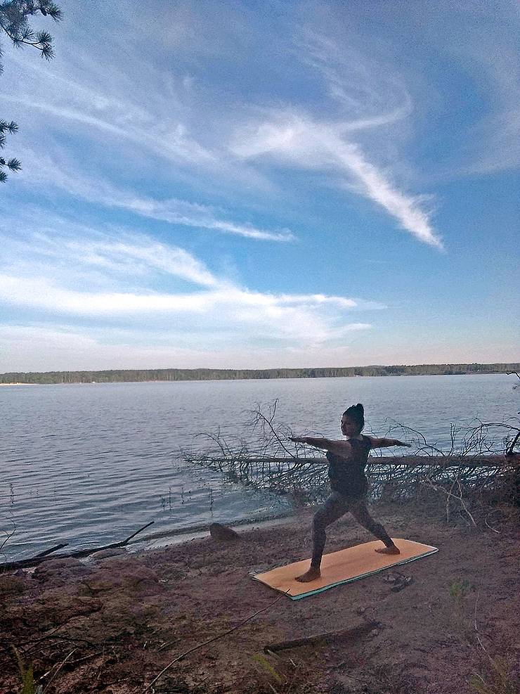 Monica Meza does sunrise yoga during a camping trip on the shores of Jordan Lake over the summer. Photo courtesy of Monica Meza.