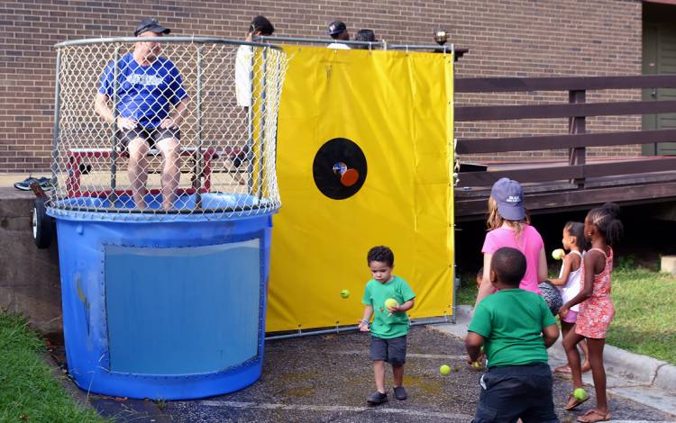 Duke Police Assistant Chief James Bjurstrom sits in the dunk tank as children prepare to take aim. 