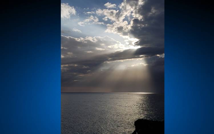 Sunlight and clouds over the ocean.