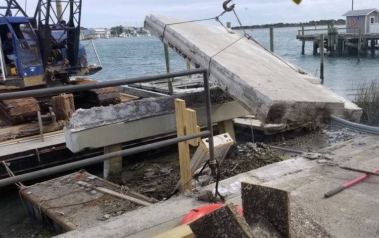 Construction crews install a new dock at the Duke Marine Lab that will better withstand storms.