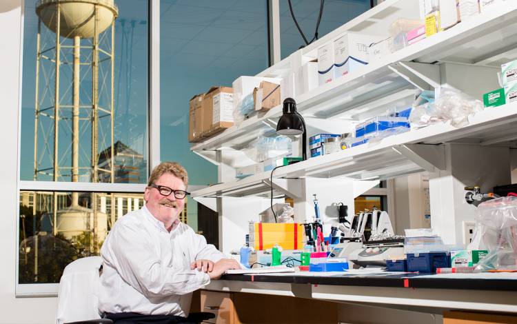Christopher Newgard works in his lab in the Carmichael Building, a former tobacco warehouse that now houses space for innovation and collaboration.
