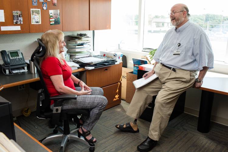 Ken Kuzenski, right, speaks with a co-worker at the Duke Adult Bone Marrow Clinic. 