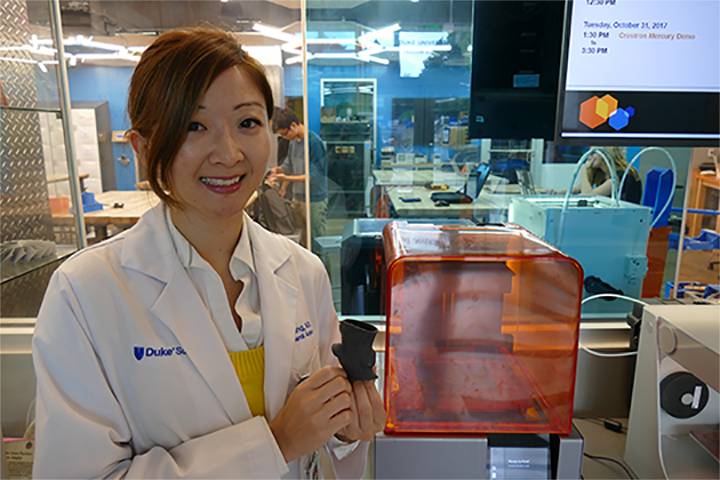 Dr. Alice Wang shows off a 3-D printed heart valve. The valve is one of several personalized patient models she has made using Duke’s dedicated 3-D printing studio. Photo by Jeannine Sato.