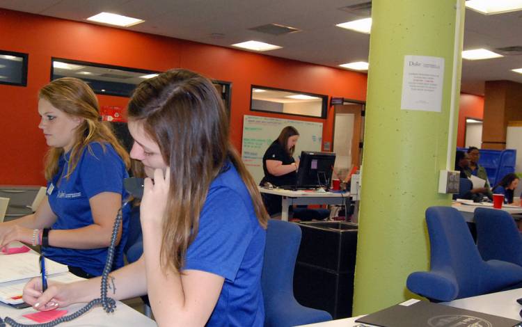 Student workers Amy Bounds, left, and Maggie Szigethy answer phones in the UCAE office.
