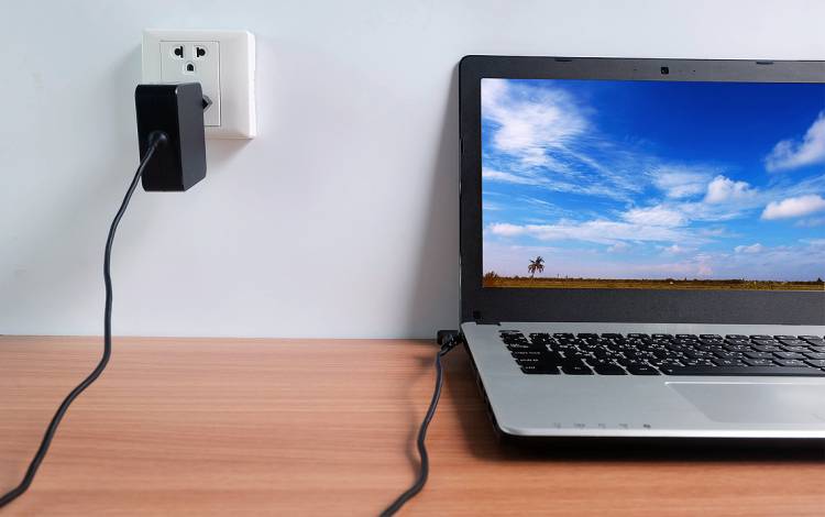 A computer plugged into a wall.