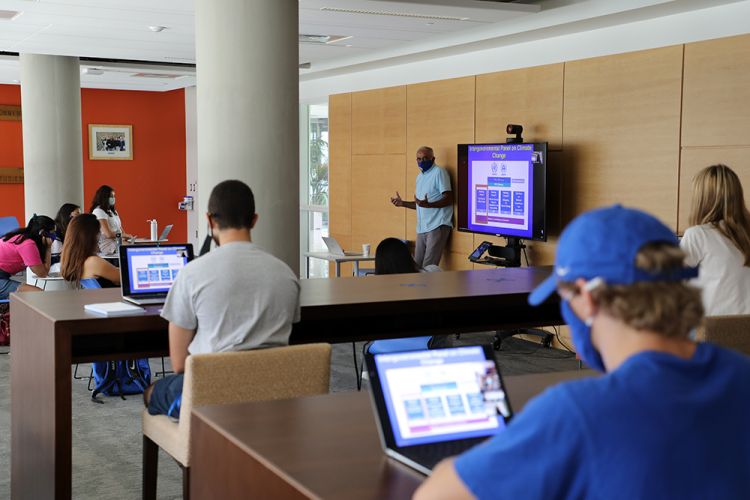 An instructor lectures in a Duke University campus classroom. 