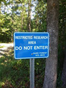 sign marked restricted area inDuke Forest