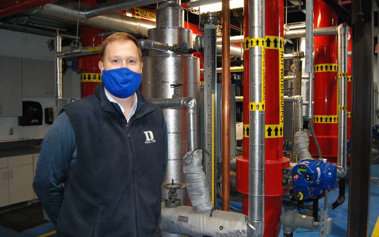 Duke Facilities Management Operations Engineer Chris Silcott helps oversee Hot Water Plant No. 2. Photo by Stephen Schramm.