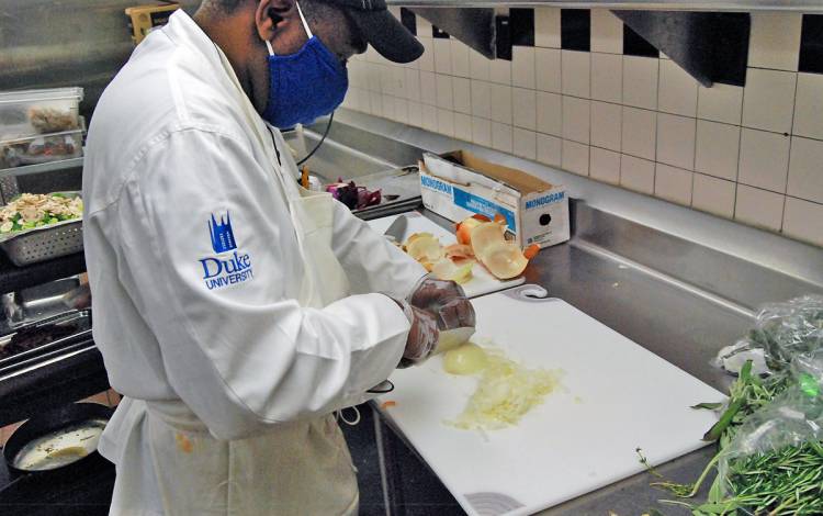 Sous chef Valentine Mitchell cuts onions on Monday. Photo by Jack Frederick.
