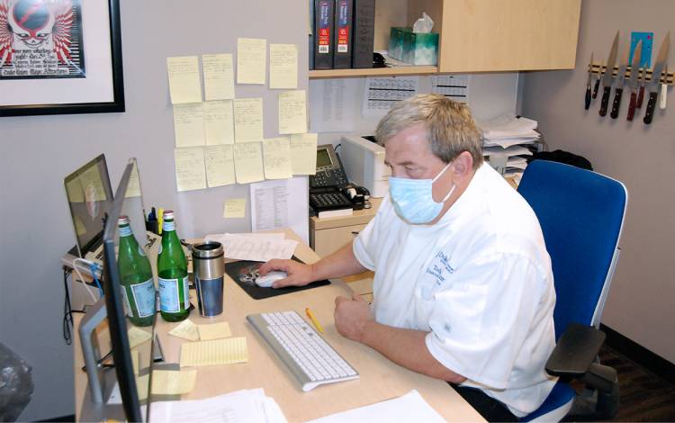 Todd Dumke looks over his notes on previous meals while working on the 2021 order in October. Photo by Jack Frederick.