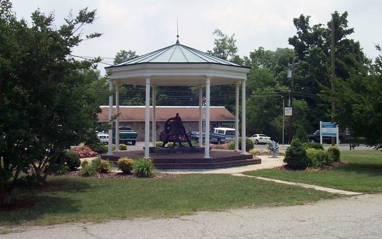 A ceremonial bell enclosed in a gazebo is one of the few reminders of Duke's roots in the small town of Trinity. Photo courtesy of Duke University Archives.