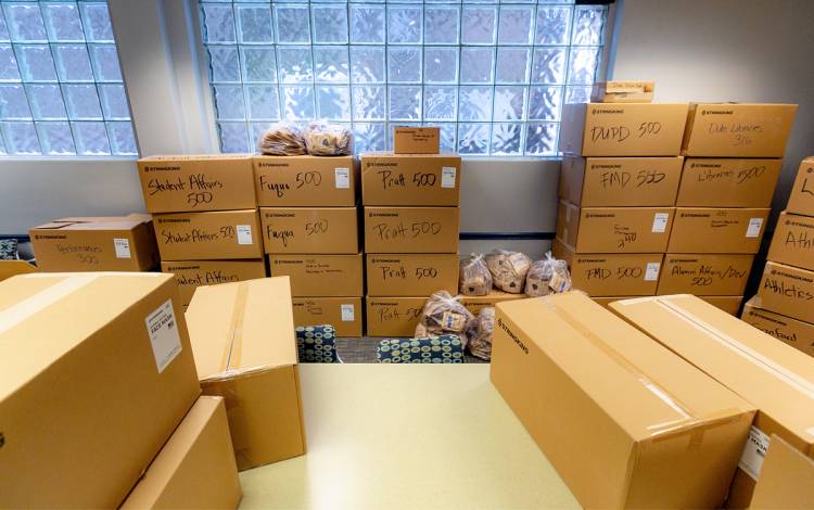 Staff organized boxes of masks in the office of Human Resource so they were ready for distribution to different schools, departments and units. Photo by Megan Mendenhall.