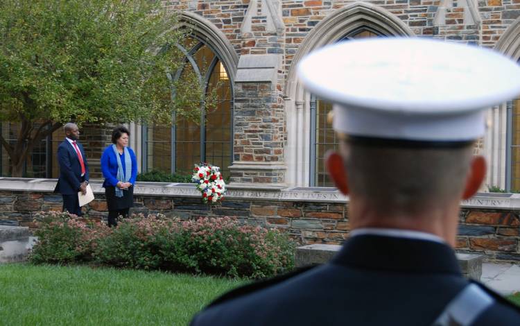 Duke's Antwan Lofton, left, and Sterly Wilder, right, place a wreath at the Duke Memorial Wall.