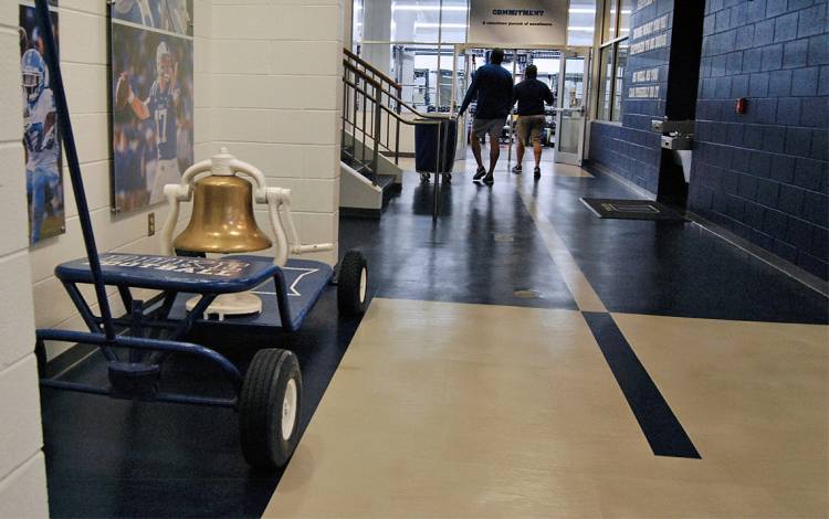 For the past few years, the Victory Bell has lived in a central spot in the Yoh Football Center. Photo by Stephen Schramm.