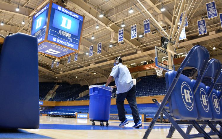 William Harris begins his post-game routine by cleaning the Cameron Indoor Stadium court. Photo by Stephen Schramm.