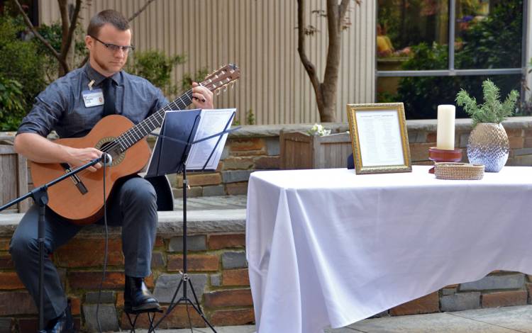 William Dawson performs at a recent memorial for employees.
