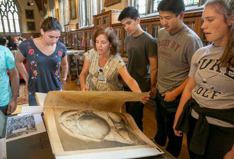 Rachel Ingold, curator of the History of Medicine collection, discusses William Hunter's 1774 anatomical drawings, which revolutionized the study of the pregnant body. Photo by Jared Lazarus.