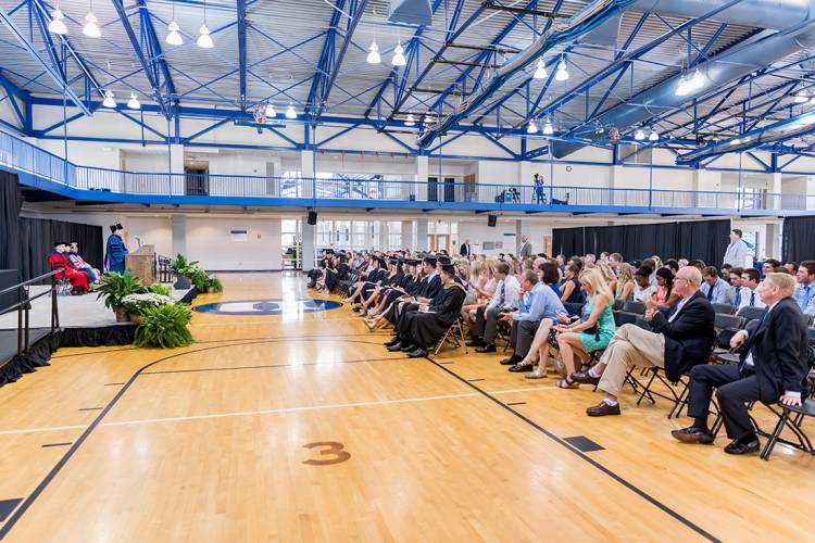 Student-athletes, family members and friends listen at a special graduation ceremony Monday.