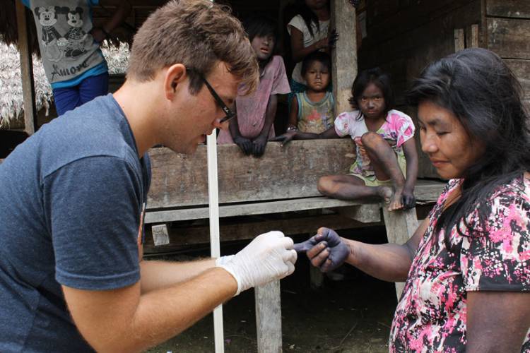 Student Josh Grubbs providing a health check in Peru.