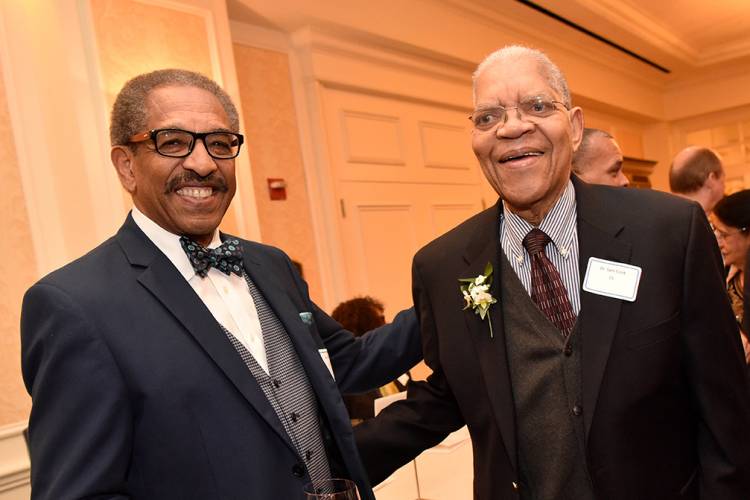 Vice President Benjamin Reese greets Cook at a Cook Society dinner.