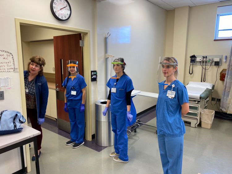 Nursing students demonstrating the printed face shields in the Duke University School of Nursing