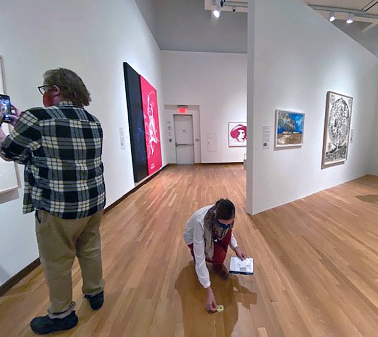 J Caldwell, left, and Molly Boarati, right, map out hot spots for the virtual tour of the Graphic Pull exhibition. Photo by Wendy Hower.