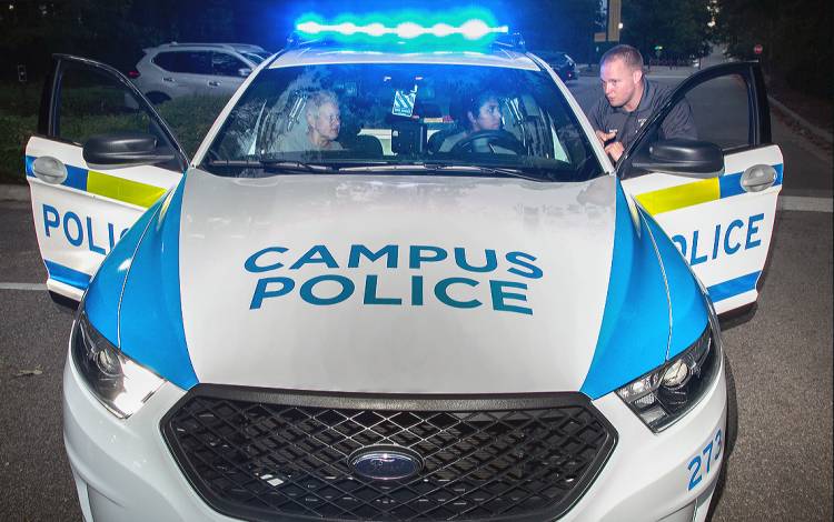 Duke University Police Officer Aaron Pruka, right, works with Duke Citizens Police Academy participants Jill Roncoroni, left, and Janeli McNeal.