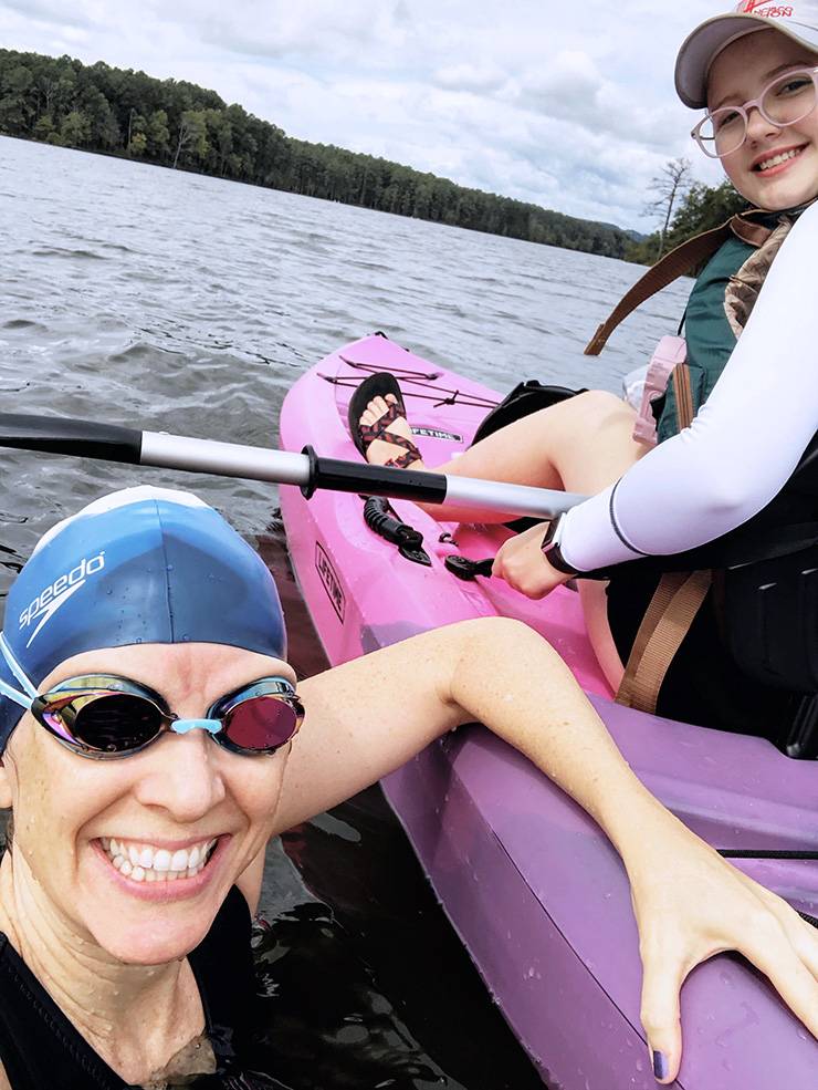 Prior to her surgery, Brie Russell would work to get stronger by swimming at Jordan Lake with her daughter, Nori. Photo by Brie Russell.