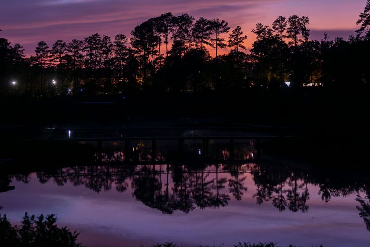 The sunset is reflected on the water of the West Campus reclamation pond. Photo by Megan Mendenhall.