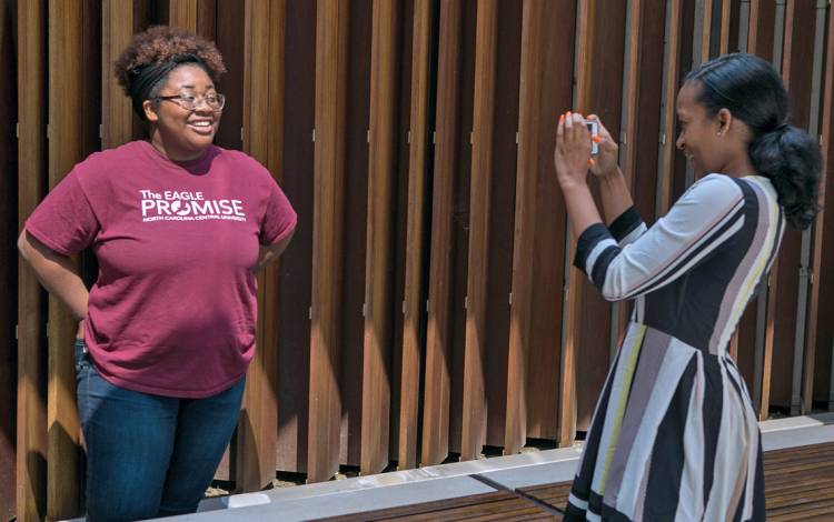 NCCU interns Palace Jones, left, poses for a photo for Maya O’Neal during a photography workshop at the Brodhead Center. Photo by Jonathan Black.