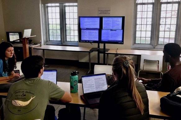 Duke students work on a translation exercise in class