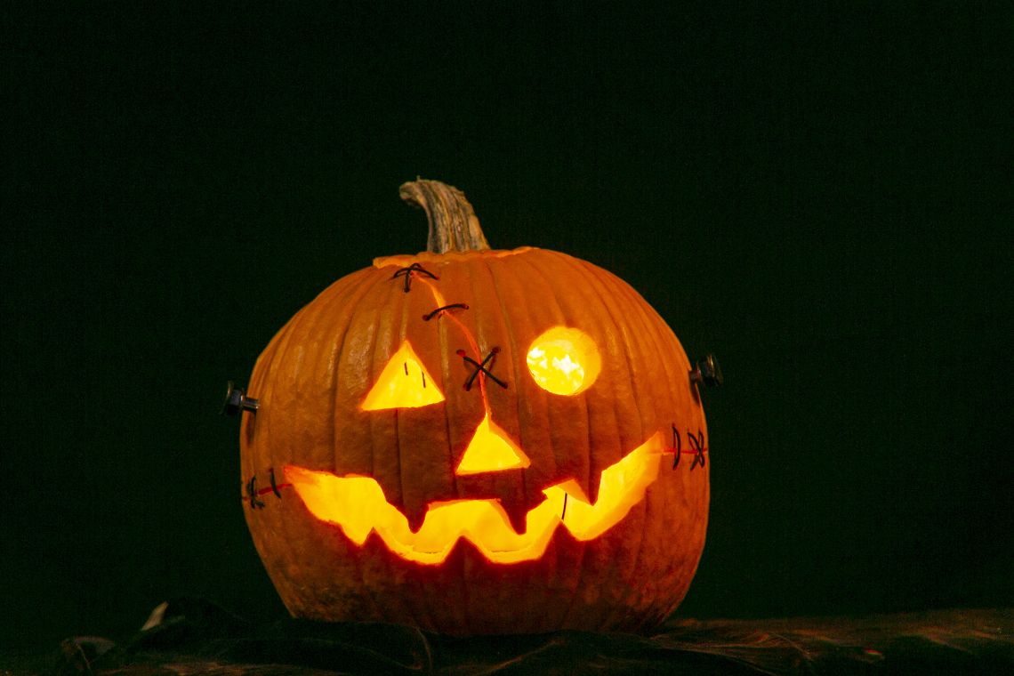 A pumpkin carved with a smiling face.