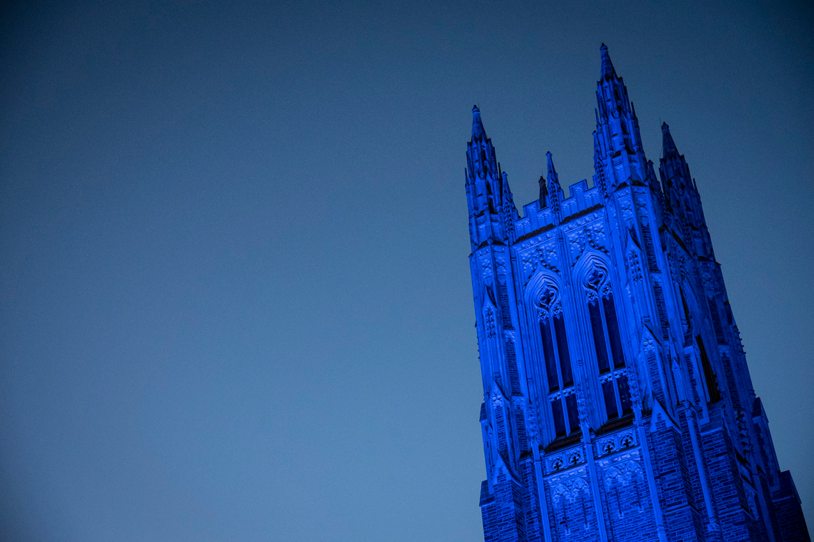 photo of the Duke Chapel bathed in blue light
