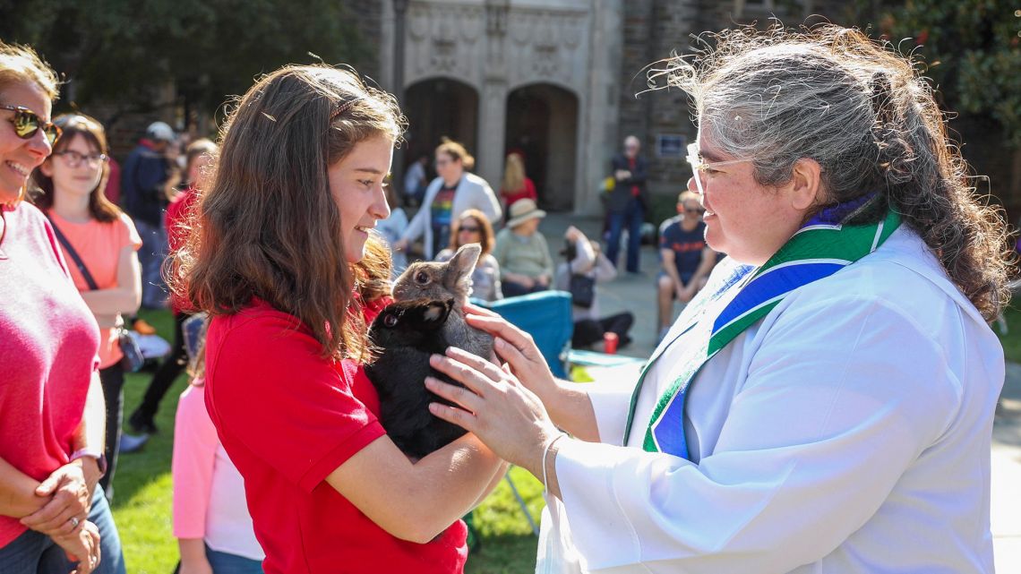 Rev. Breana van Velzen, Duke Chapel's community minister, blesses a pair of rabbits.