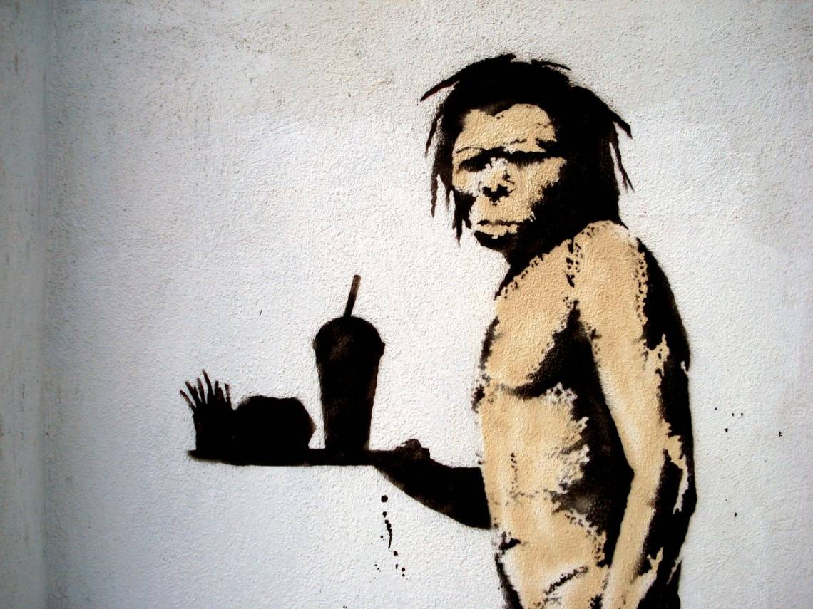 Caveman with fast food by Banksy. Licensed under CC BY 2.0. Source: Lord Jim https://www.flickr.com/photos/lord-jim/2245362817