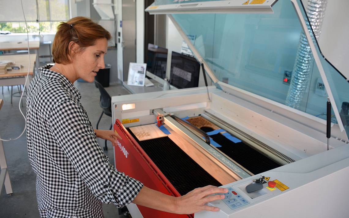 Raquel Salvatella de Prada uses the laser cutter in the Rubenstein Arts Center makerspace to create an art installation. Photo by Jonathan Black.