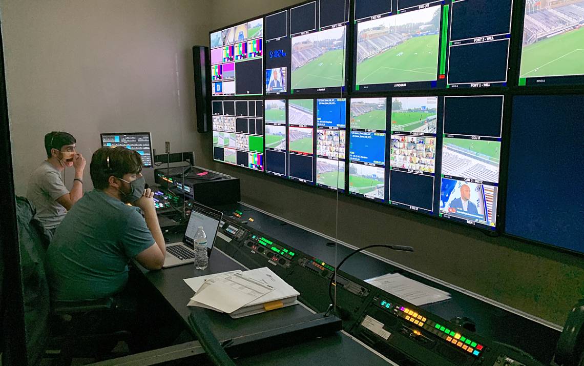 Blue Devil Network staff members work in the control room.
