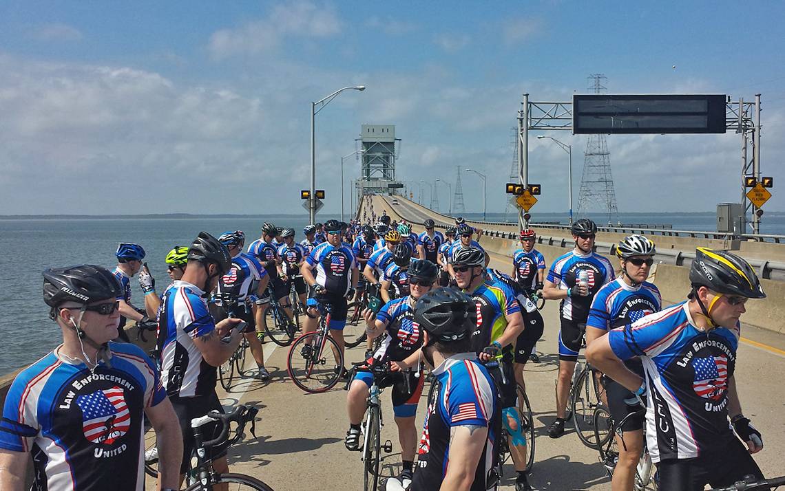 Riders in the Road to Hope stop on James River Bridge in Virginia.