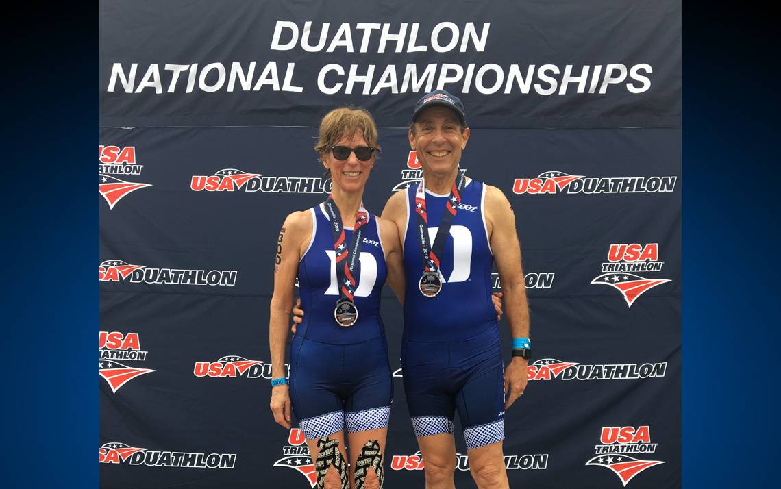 Duke faculty members Rochelle Schwartz-Bloom, left, and Paul Bloom, right, show off their medals at the Duathlon National Championships. Submitted photo.