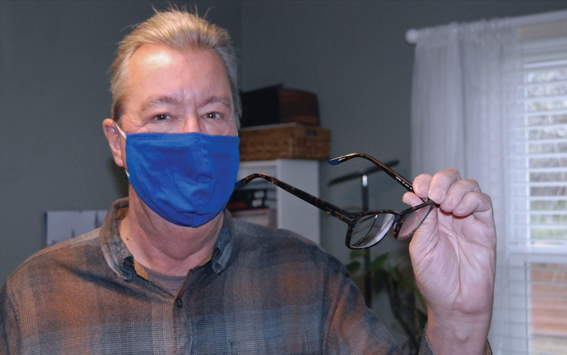 Bob Baldwin shows off computer glasses at his home office in Durham. Photo by Jack Frederick.