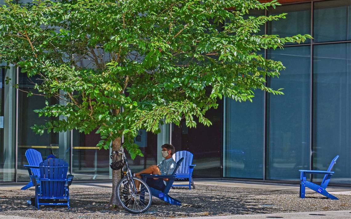 Someone enjoys one of Duke's new Adirondack chairs outside of the Rubenstein Arts Center. Photo by Mark Hough.