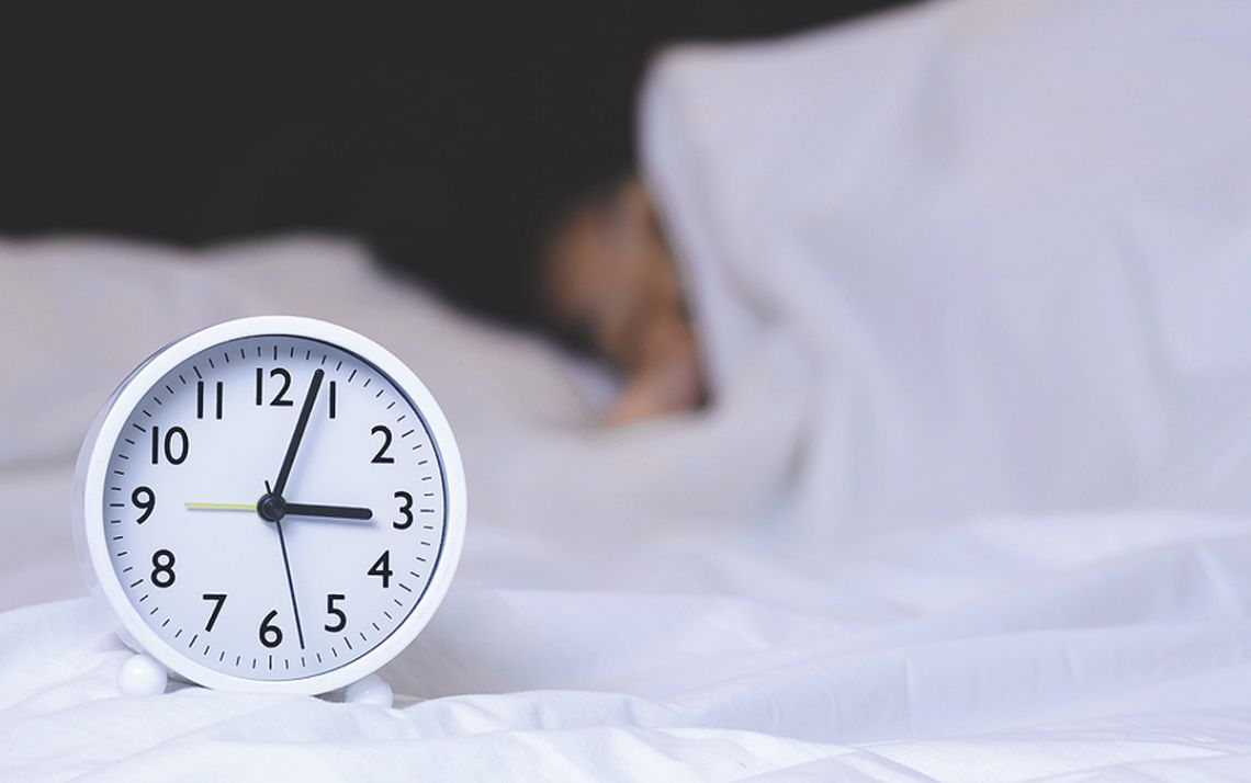 A clock and a person sleeping.