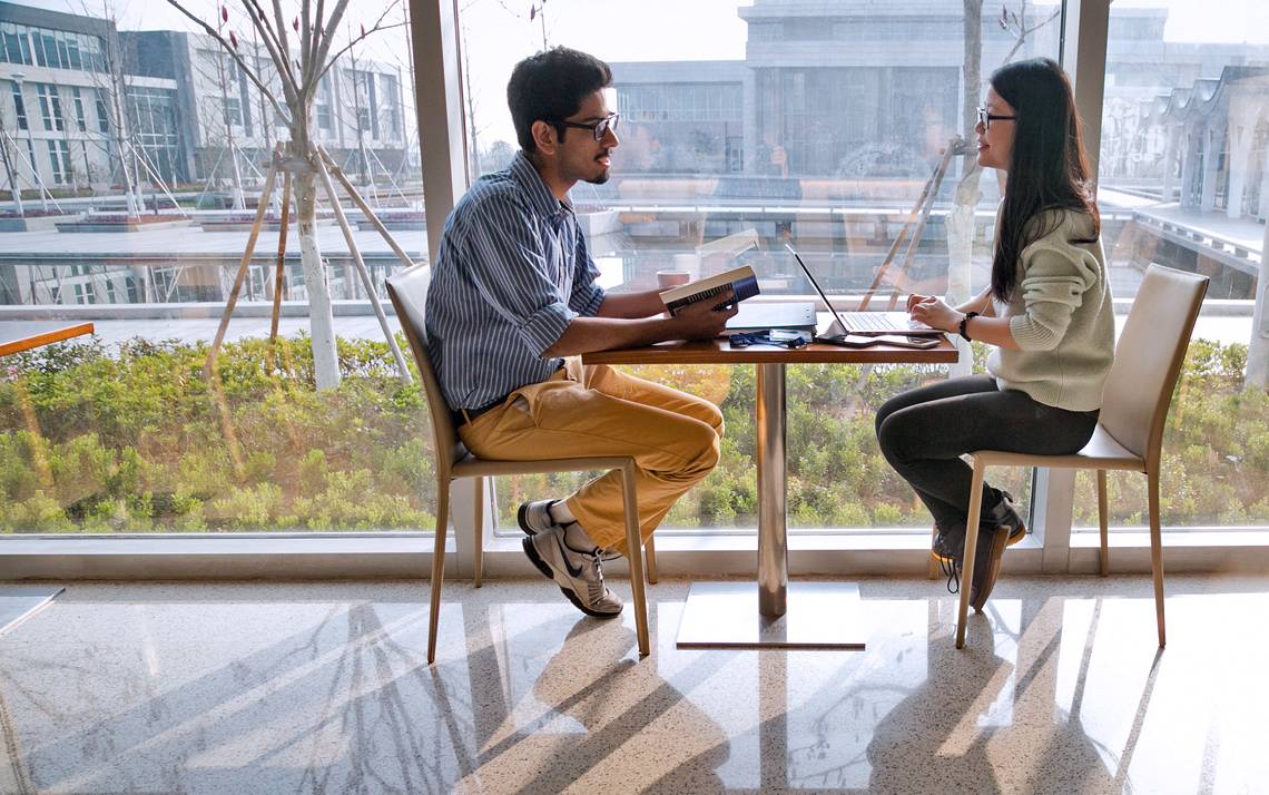 Two students on the campus of Duke Kunshan University.