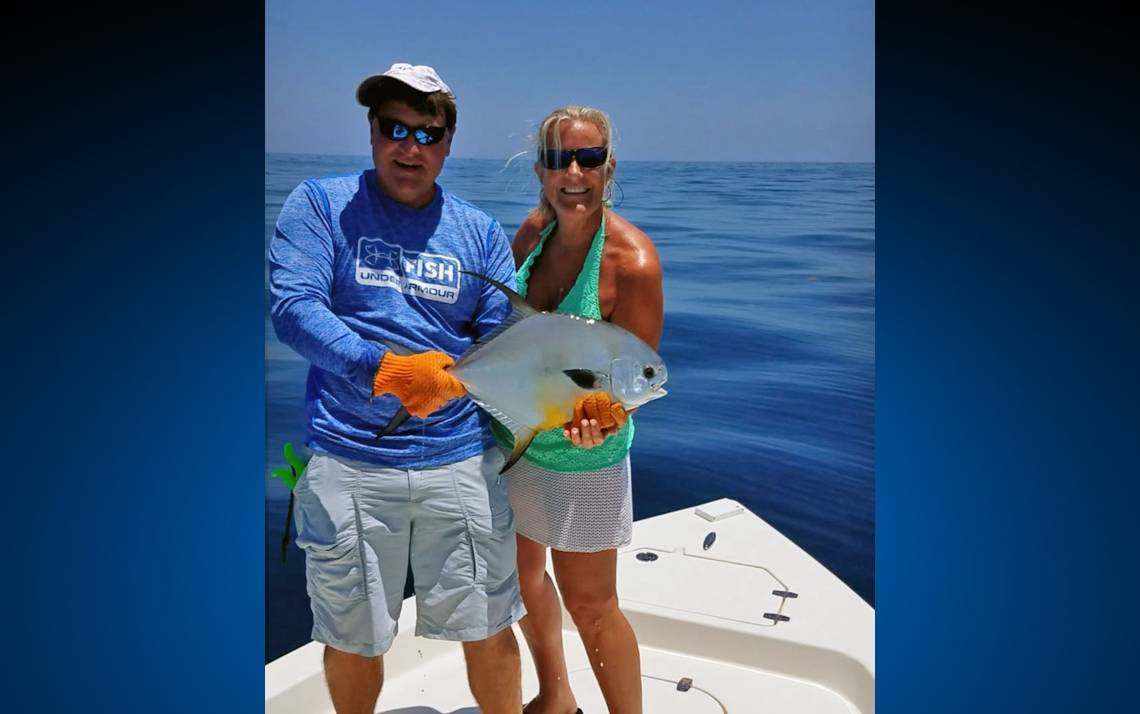 Dot Mishoe, right, holds her prized Permit fish with friend, Robert Miller, in Florida. Photo courtesy of Dot Mishoe. 